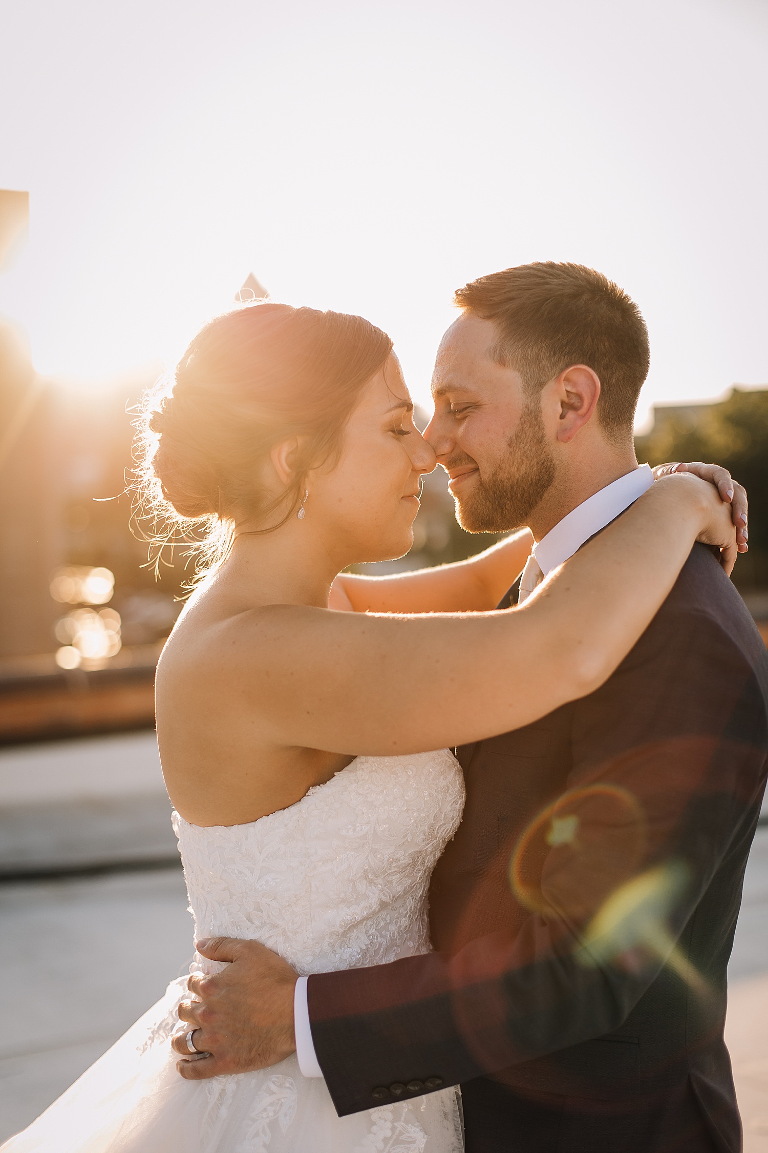 bride and groom at sunset after getting married and wearing new wedding bands 