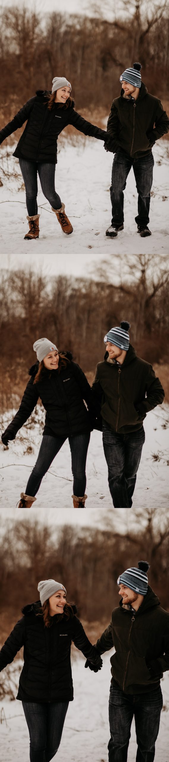 Engaged couple wearing blue jeans while holding hands and staying warm during snowy engagement session