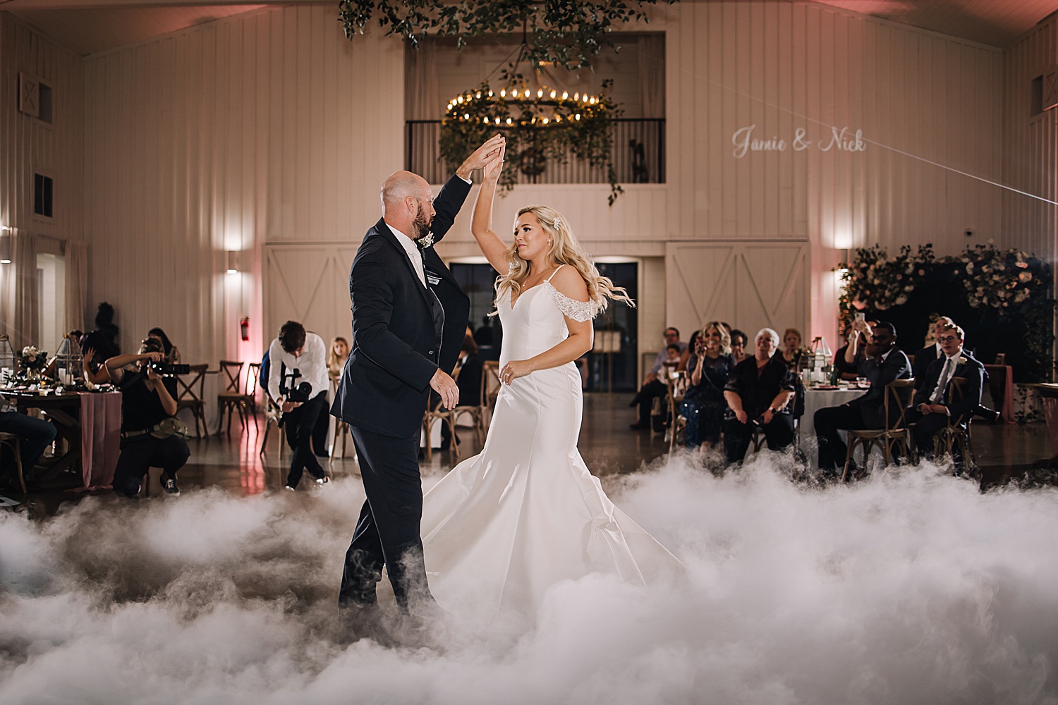 Bride and groom share first dance at the farmhouse wedding reception with Michigan wedding photographer 